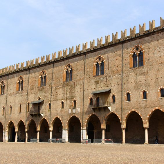 Mantua, Italy - June 15, 2013: The Captain's Palace in Piazza Sordello, was built by Paolo Bonacolsi at the beginning of the 14th century and it is one of the most ancient parts of the complex called Palazzo Ducale (Ducal Palace). Mantua, Lombardy, Italy. Some people around.